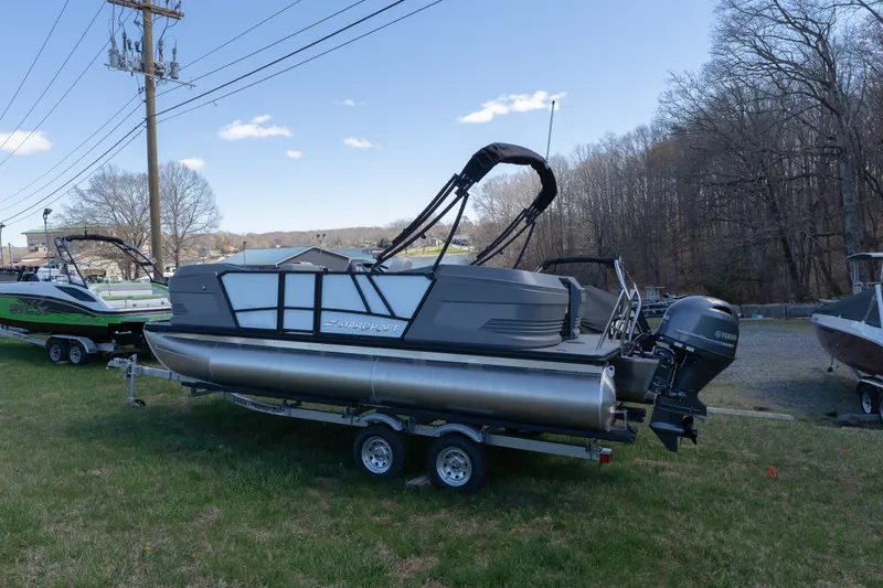 Slide: The Image of 2026 Starcraft GX 20 R DH pontoon boat on trailer, parked on grass. - 3