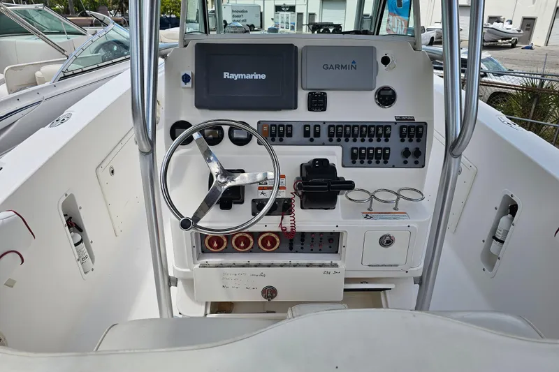 Slide: The Image of 2007 Wellcraft 30 Scarab Tournament boat seating with white upholstery and storage compartments. - 12