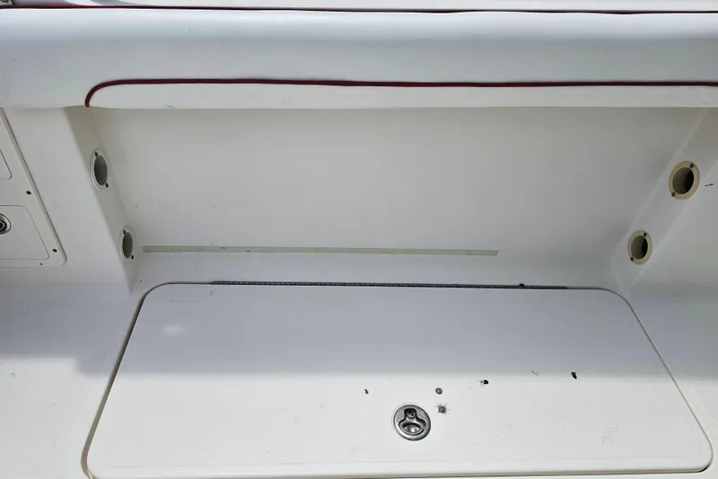 Slide: The Image of 2007 Wellcraft 30 Scarab Tournament boat seating with white upholstery and storage compartments. - 13