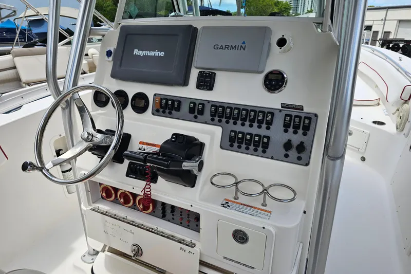 Slide: The Image of 2007 Wellcraft 30 Scarab Tournament boat interior with white seating and red accents. - 14