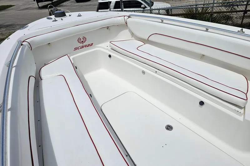 Slide: The Image of 2007 Wellcraft 30 Scarab Tournament boat interior with white seating and red trim. - 19