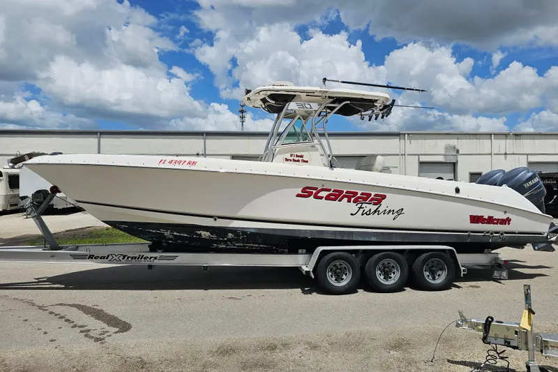 Slide: The Image of 2007 Wellcraft 30 Scarab Tournament boat on trailer under cloudy sky. - 2