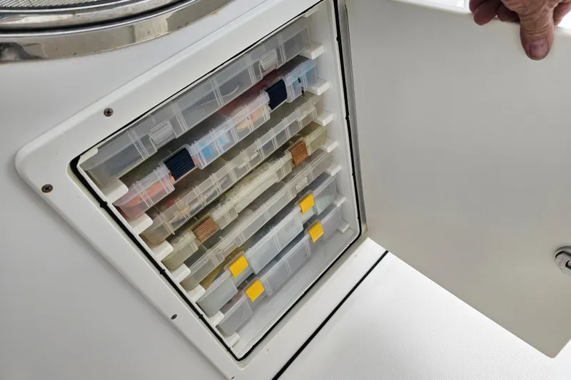 Slide: The Image of Storage compartment with organized tackle boxes on a 2007 Wellcraft 30 Scarab Tournament boat. - 27