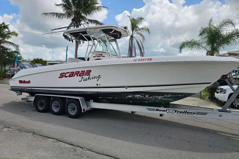 Slide: The Image of 2007 Wellcraft 30 Scarab Tournament boat on trailer under cloudy sky. - 3