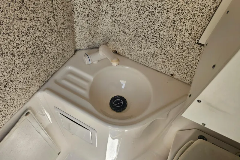 Slide: The Image of Compact sink area in 2007 Wellcraft 30 Scarab Tournament boat interior. - 36