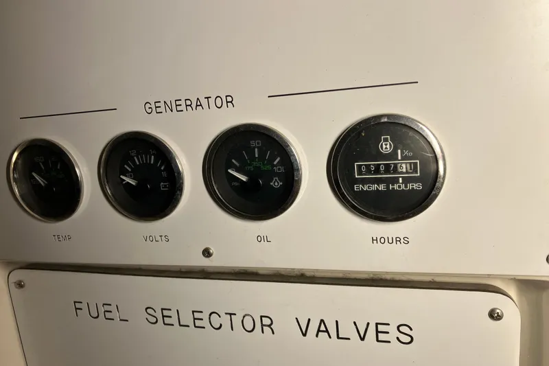 Slide: The Image of Generator control panel of 2002 Sea Ray 410 Sundancer with gauges for temperature, volts, oil, and engine hours. - 18