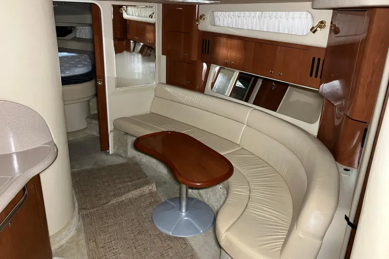 Slide: The Image of Luxurious interior of a 2002 Sea Ray 410 Sundancer yacht with leather seating and wood accents. - 14