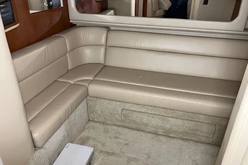 Slide: The Image of Interior of 2002 Sea Ray 410 Sundancer with beige leather seating and carpeted flooring. - 20