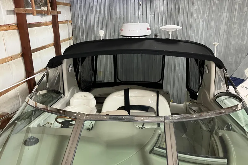 Slide: The Image of 2002 Sea Ray 410 Sundancer boat interior with black canopy in storage. - 25