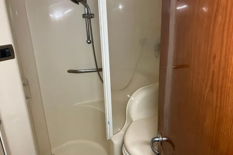 Slide: The Image of Shower area inside 2002 Sea Ray 410 Sundancer yacht, featuring a compact design. - 24