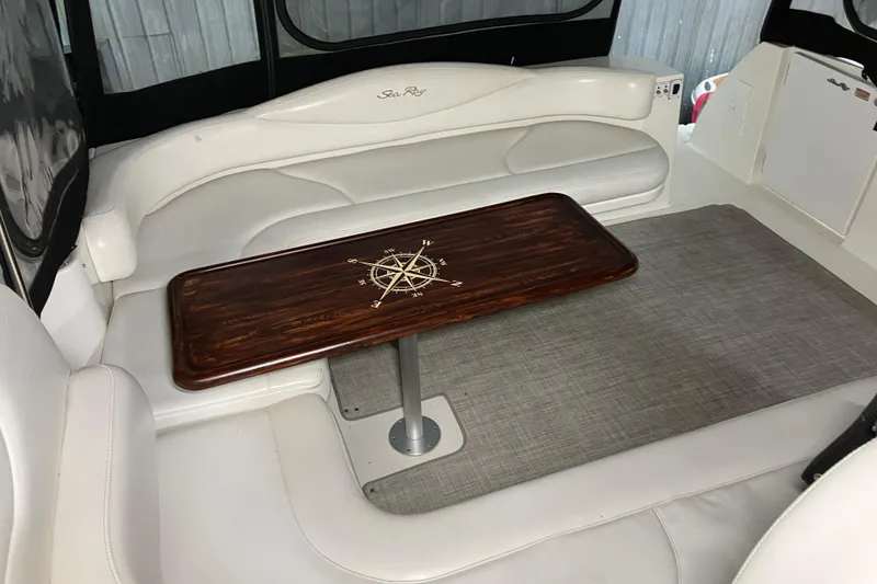 Slide: The Image of Luxurious interior of 2002 Sea Ray 410 Sundancer with elegant wood table and plush seating. - 11