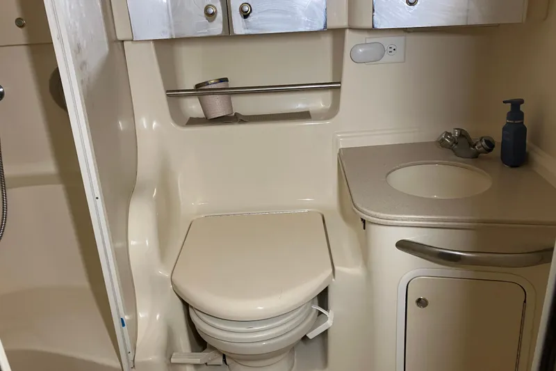 Slide: The Image of Bathroom interior of 2002 Sea Ray 410 Sundancer yacht, featuring toilet and sink. - 23