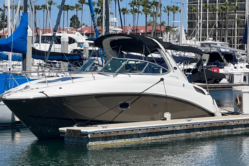 The Image of 2013 Sea Ray Sundancer 280 docked at a marina with sailboats in the background. - 0