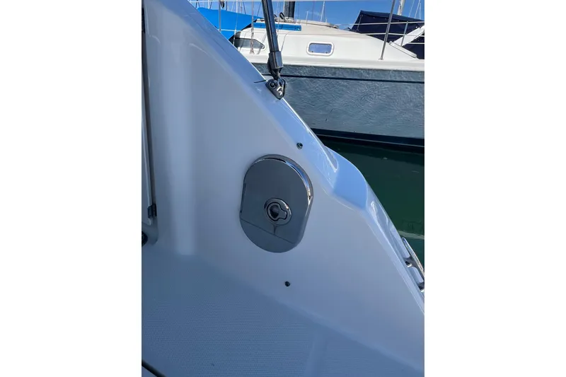 Slide: The Image of 2013 Sea Ray Sundancer 280 boat detail with chrome fixture, docked beside another vessel. - 11