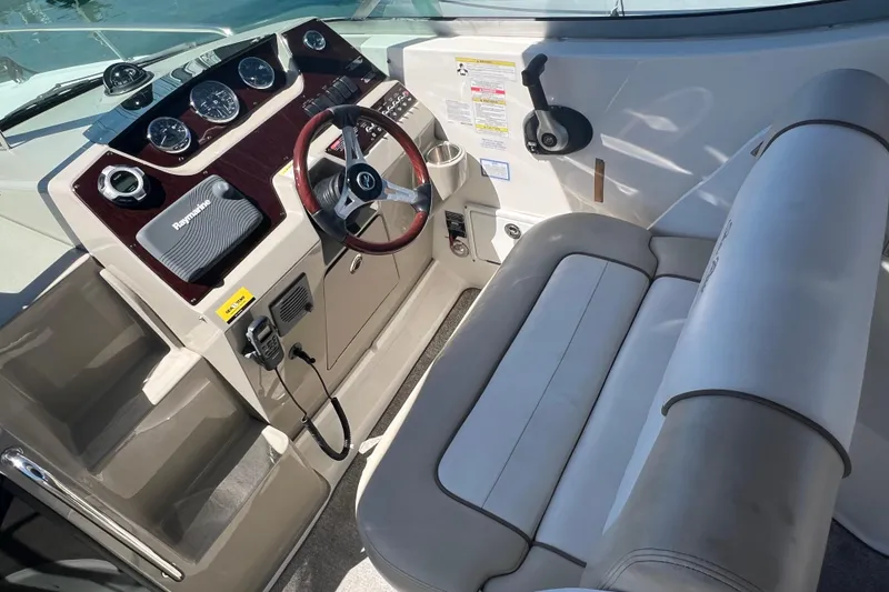 Slide: The Image of Cockpit of 2013 Sea Ray Sundancer 280 with steering wheel and navigation instruments. - 14