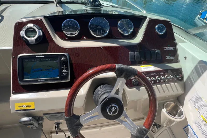 Slide: The Image of Dashboard of 2013 Sea Ray Sundancer 280 with navigation system and controls. - 16