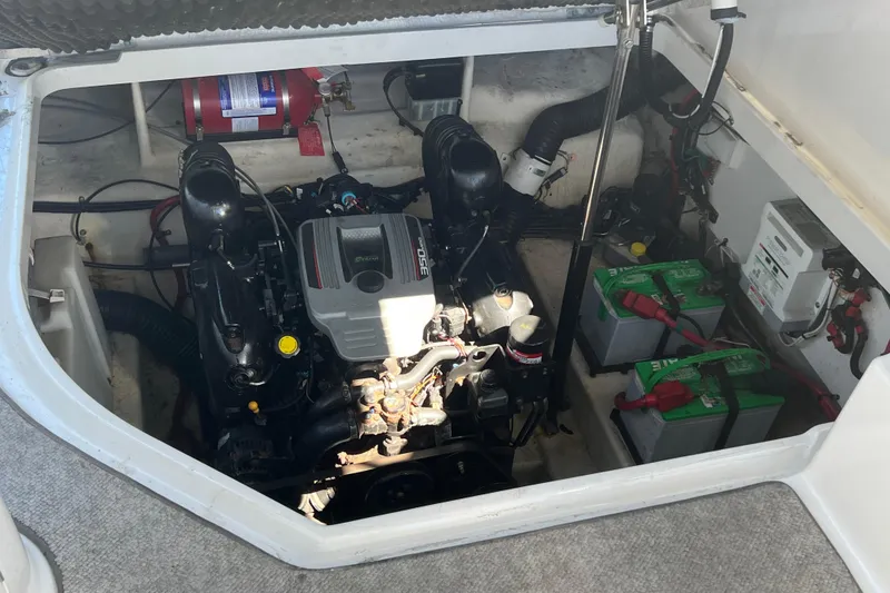 Slide: The Image of Engine compartment of a 2013 Sea Ray Sundancer 280 with visible batteries and fire extinguisher. - 26