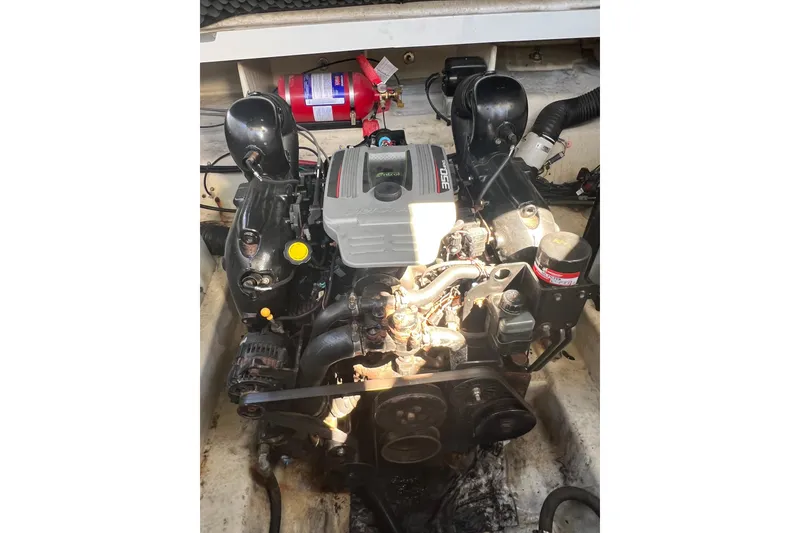 Slide: The Image of Engine compartment of a 2013 Sea Ray Sundancer 280 boat with visible components. - 27
