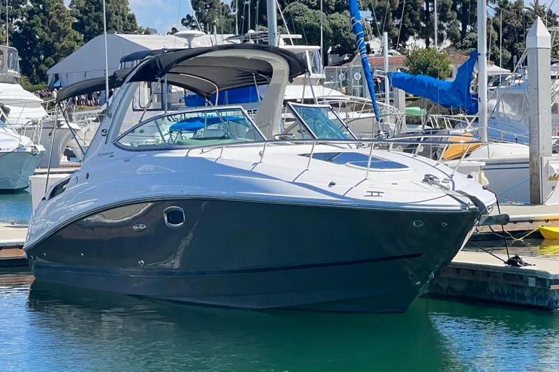 Slide: The Image of 2013 Sea Ray Sundancer 280 docked at a marina, showcasing sleek design and modern features. - 3