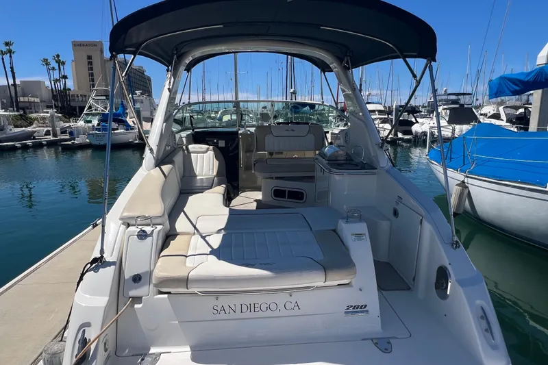 Slide: The Image of 2013 Sea Ray Sundancer 280 docked in San Diego marina, featuring spacious seating and canopy. - 7