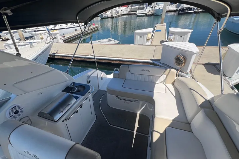Slide: The Image of 2013 Sea Ray Sundancer 280 interior with seating and kitchenette at marina. - 8