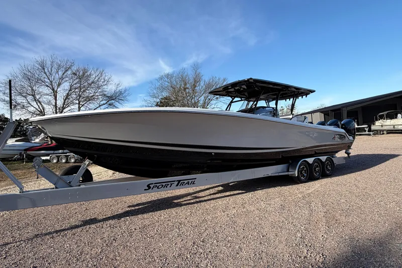 The Image of 2022 Nor-Tech 390 Sport Center Console boat on trailer, parked outdoors. - 0