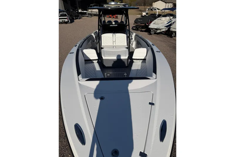 Slide: The Image of 2022 Nor-Tech 390 Sport Center Console boat with sleek white seating and spacious deck. - 11