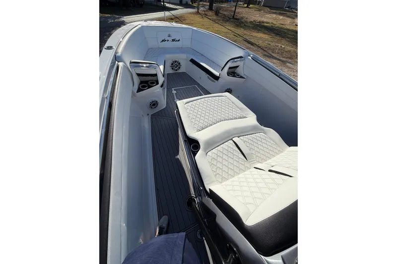 Slide: The Image of 2022 Nor-Tech 390 Sport Center Console boat interior with luxurious seating and modern design. - 12