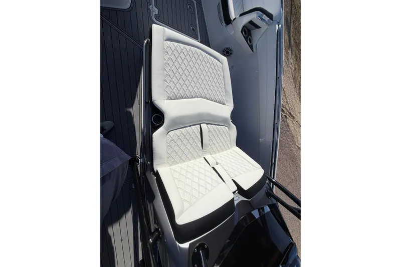 Slide: The Image of Luxury seating on 2022 Nor-Tech 390 Sport Center Console boat, featuring diamond-stitched upholstery. - 13