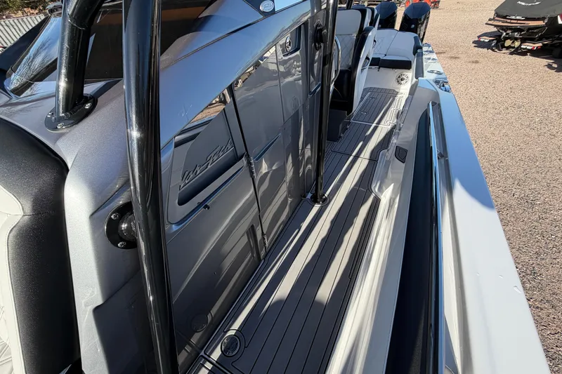 Slide: The Image of 2022 Nor-Tech 390 Sport Center Console boat, sleek design, side view, outdoor setting. - 16