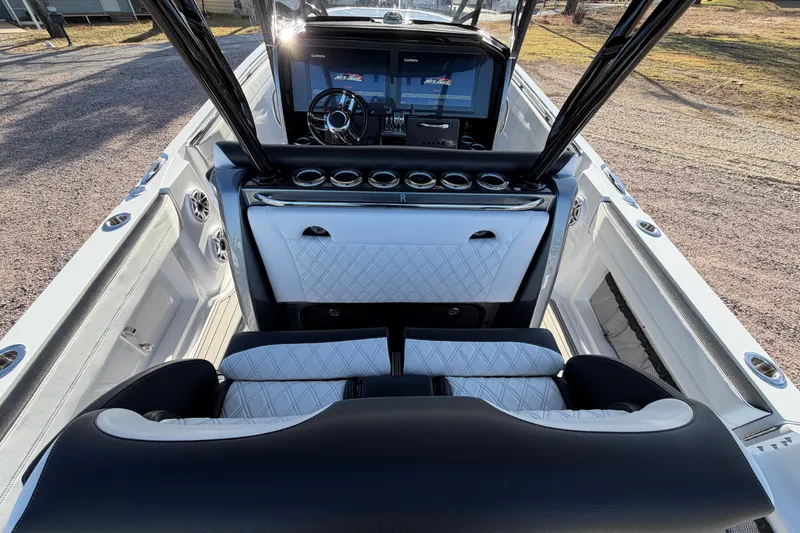 Slide: The Image of 2022 Nor-Tech 390 Sport Center Console interior with luxurious seating and advanced dashboard. - 20