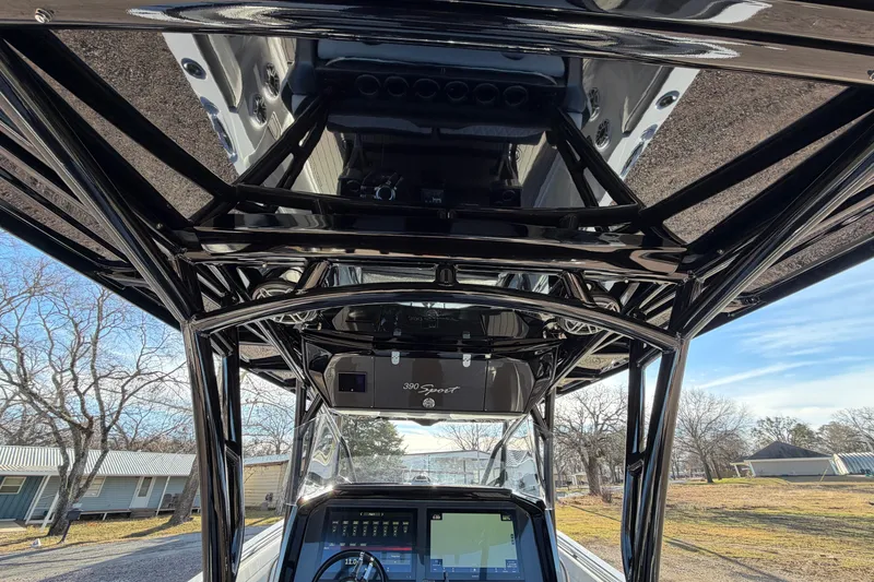Slide: The Image of 2022 Nor-Tech 390 Sport Center Console boat with sleek black framework and advanced dashboard. - 21