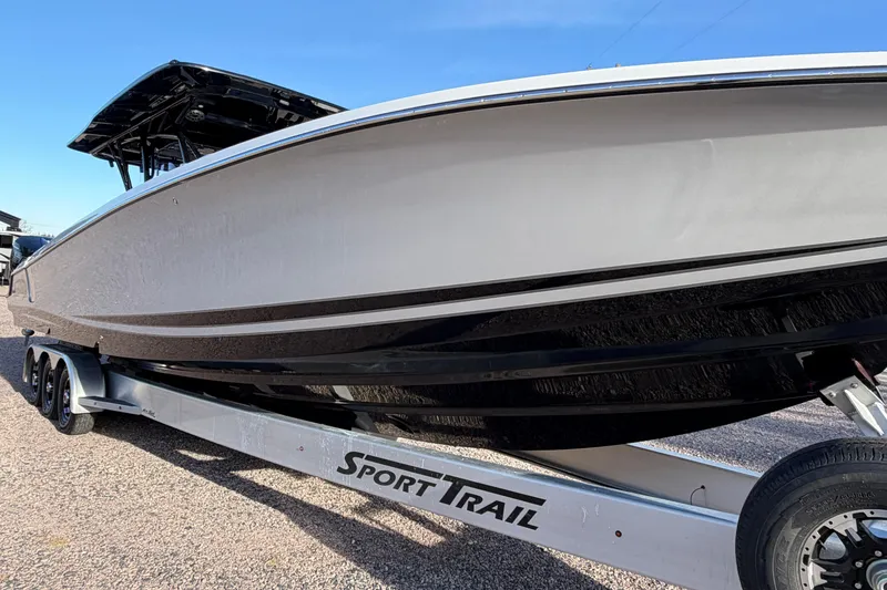 Slide: The Image of 2022 Nor-Tech 390 Sport Center Console boat on Sport Trail trailer, side view. - 3