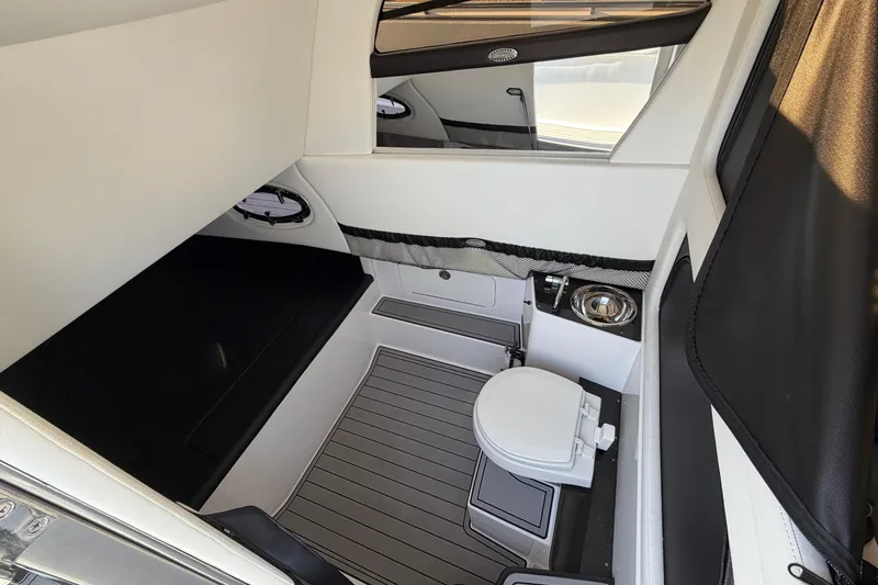 Slide: The Image of 2022 Nor-Tech 390 Sport Center Console cabin with toilet and sleek interior design. - 30