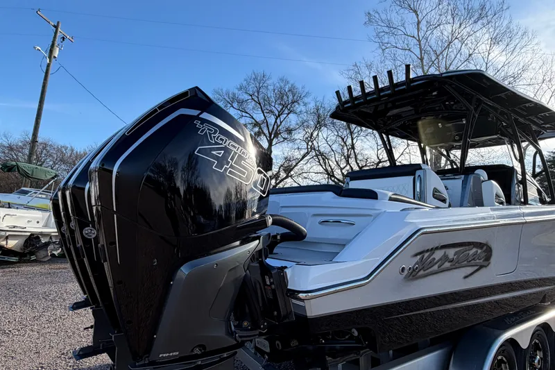 Slide: The Image of 2022 Nor-Tech 390 Sport Center Console boat with powerful Racing 450 engine, parked outdoors. - 5
