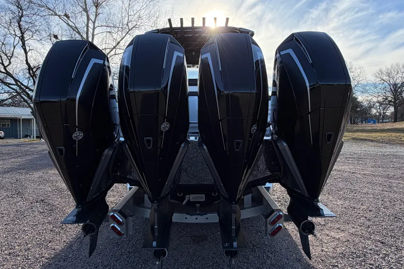Slide: The Image of Four powerful outboard motors on a 2022 Nor-Tech 390 Sport Center Console boat. - 6