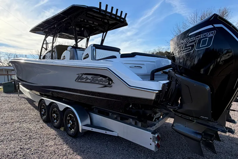 Slide: The Image of 2022 Nor-Tech 390 Sport Center Console boat with powerful outboard engine on trailer. - 7