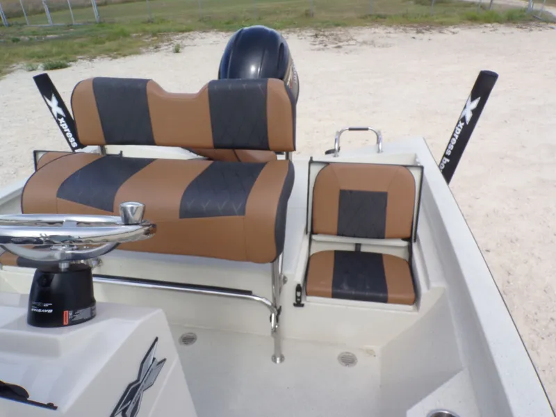 Slide: The Image of 2026 Xpress H20BAY boat with brown and black seating. - 25