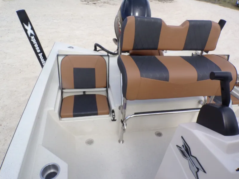 Slide: The Image of 2026 Xpress H20BAY boat with brown and black seating. - 26