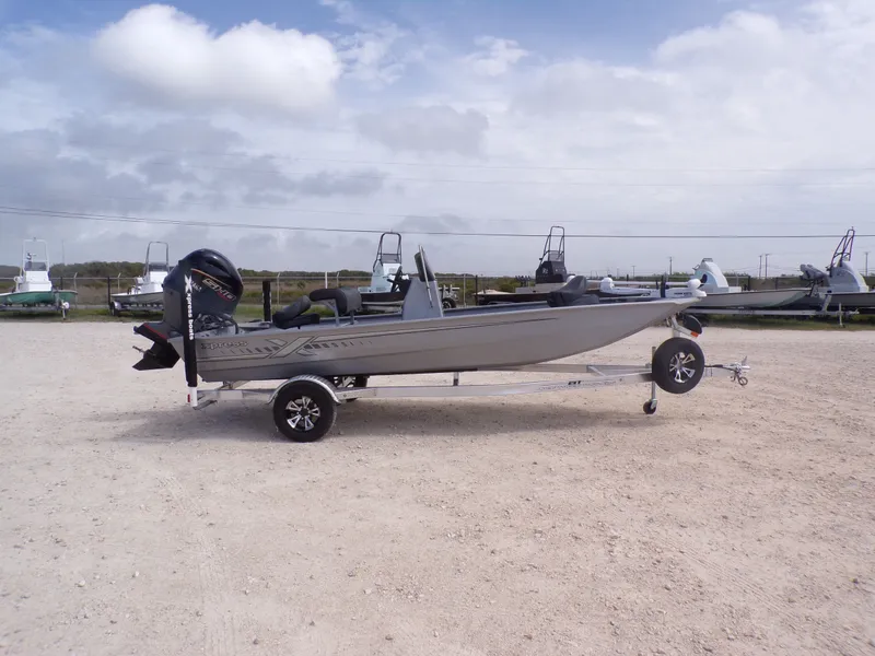 Slide: The Image of 2026 Xpress XP18CC boat parked on trailer outdoors. - 18