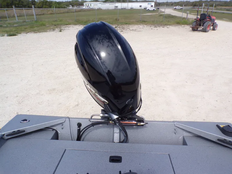 Slide: The Image of 2026 Xpress XP18CC boat with outboard motor on gravel surface. - 19