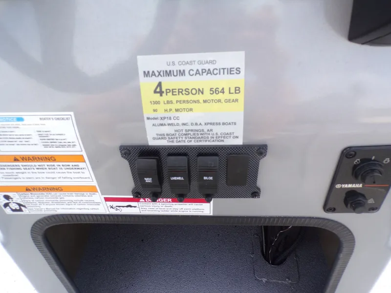 Slide: The Image of Xpress XP18CC 2026 boat capacity label and switches. - 22