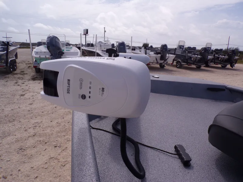 Slide: The Image of Xpress XP18CC 2026 with Minn Kota Riptide motor on boat deck. - 27