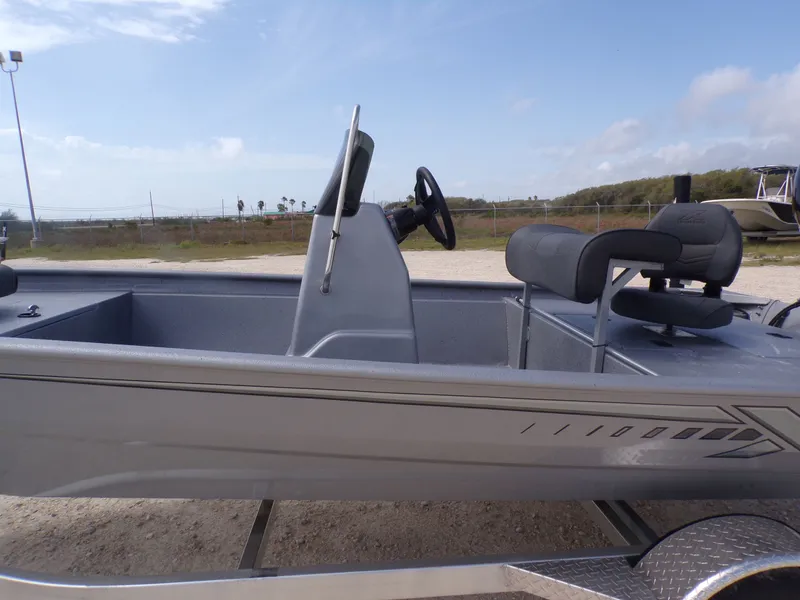 Slide: The Image of 2026 Xpress XP18CC boat with gray interior and steering console. - 36