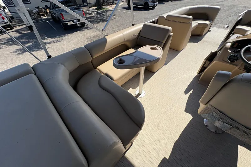 Slide: The Image of 2016 Bennington 21 SLX pontoon boat interior with beige seating and table. - 13