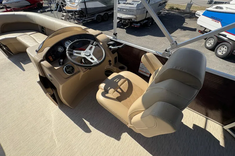 Slide: The Image of 2016 Bennington 21 SLX boat interior with beige captain's chair and steering console. - 14