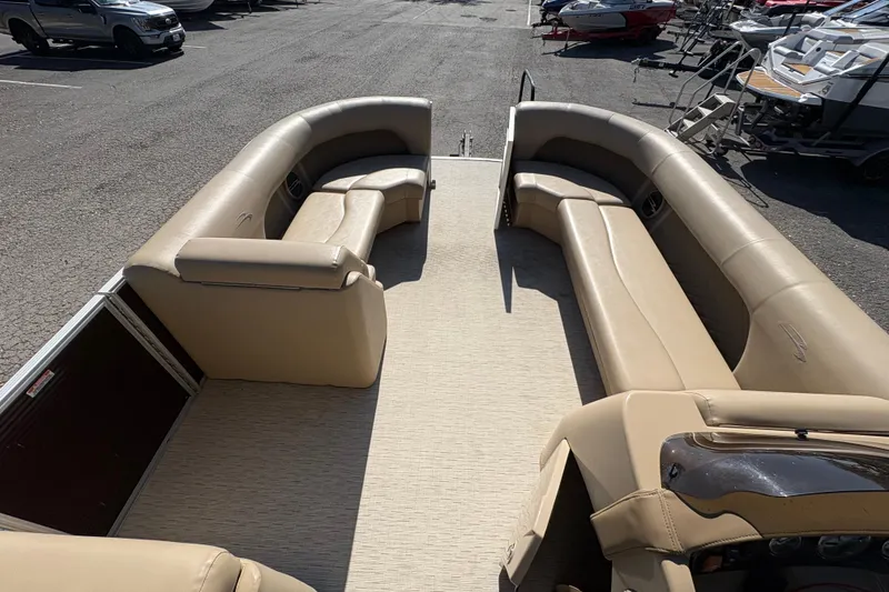 Slide: The Image of 2016 Bennington 21 SLX pontoon boat with spacious beige seating and open deck. - 24