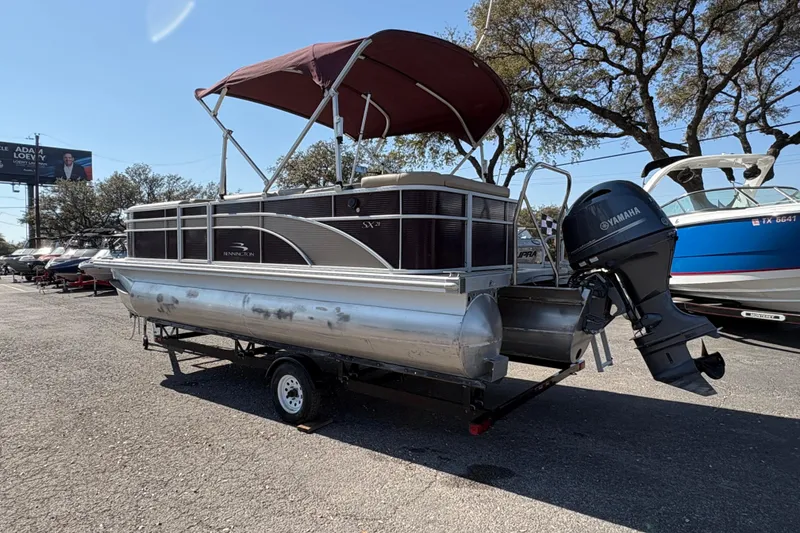 Slide: The Image of 2016 Bennington 21 SLX pontoon boat with Yamaha outboard motor on trailer. - 8