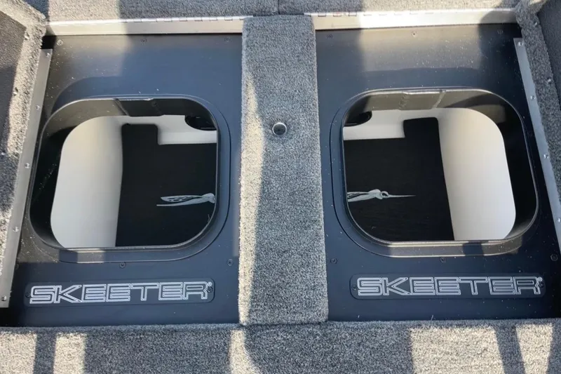 Slide: The Image of 2026 Skeeter FXR20 FLEX boat storage compartments with logo, featuring durable carpeted finish. - 15