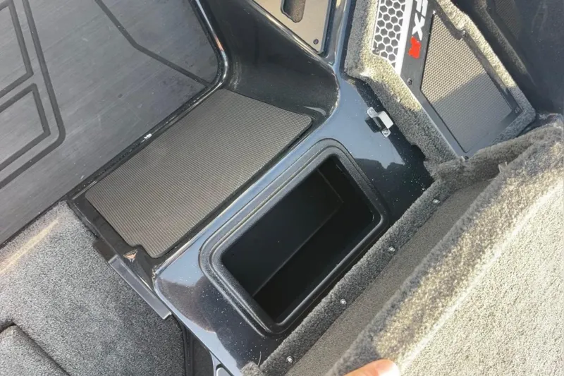 Slide: The Image of 2026 Skeeter FXR20 FLEX boat storage compartment with open lid, showcasing interior space. - 16